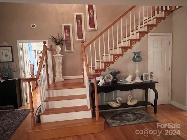 staircase with wood-type flooring