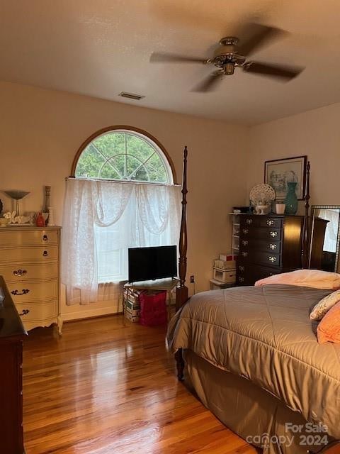 bedroom with ceiling fan and hardwood / wood-style flooring