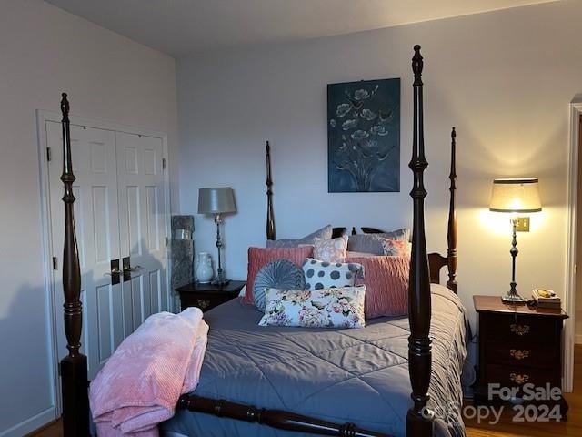 bedroom featuring hardwood / wood-style floors and a closet