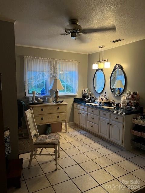 kitchen featuring a textured ceiling, ceiling fan, sink, and light tile patterned floors