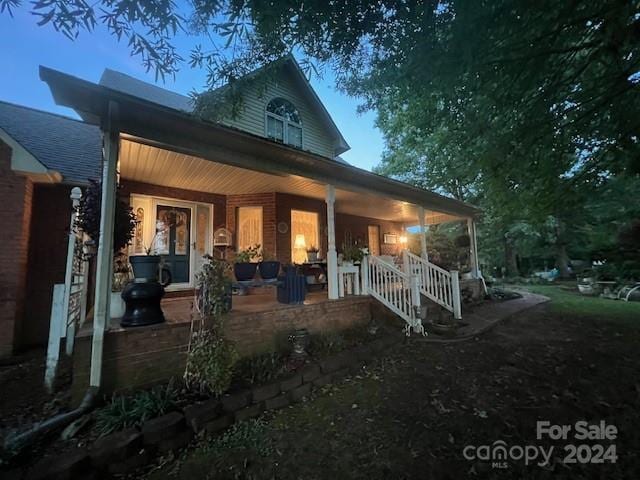 rear view of house featuring covered porch