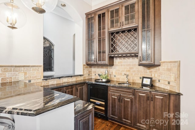 kitchen with decorative backsplash, decorative light fixtures, and dark stone counters