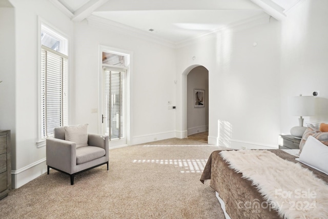 bedroom featuring beam ceiling, ornamental molding, and light carpet