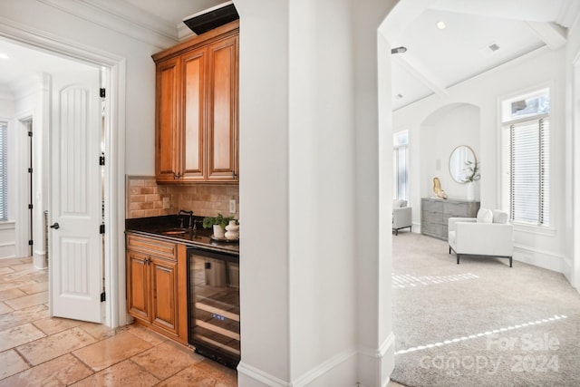 bar featuring crown molding, sink, light carpet, wine cooler, and decorative backsplash