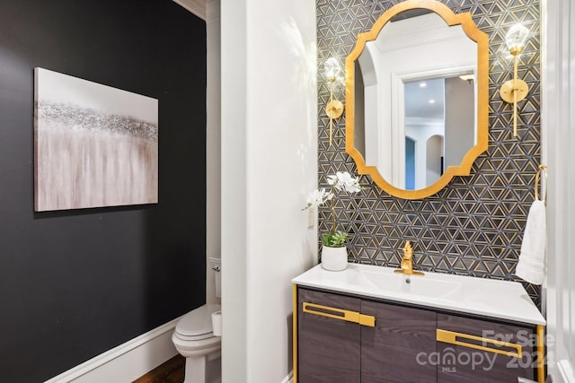 bathroom featuring tile walls, vanity, crown molding, and toilet