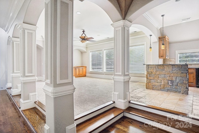 details with decorative columns, crown molding, wood-type flooring, and ceiling fan