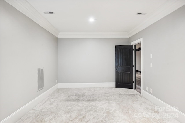 carpeted spare room featuring crown molding