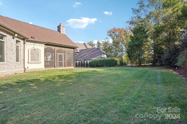 view of yard featuring a sunroom