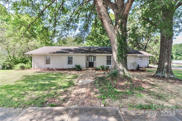 ranch-style house with a front lawn