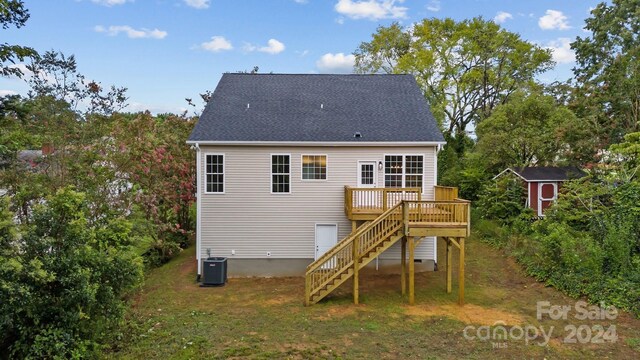 rear view of house with cooling unit and a wooden deck