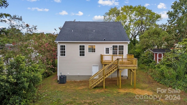 rear view of house featuring an outbuilding, a storage unit, stairway, cooling unit, and a wooden deck