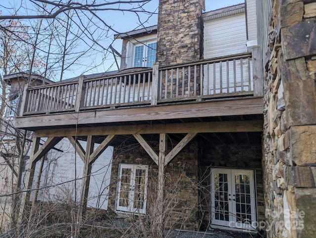 rear view of house with french doors and a balcony