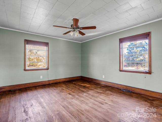 empty room with crown molding, ceiling fan, and hardwood / wood-style flooring