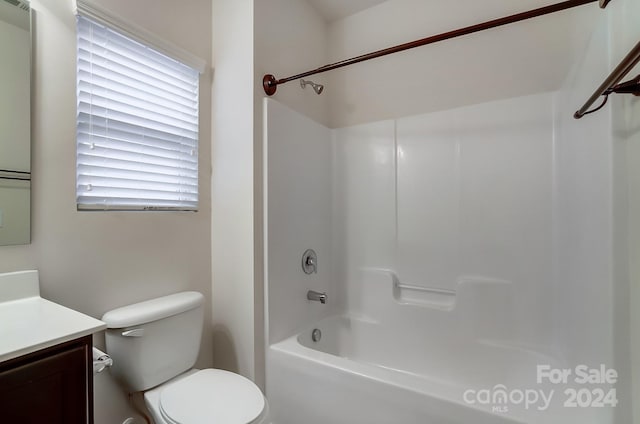 full bathroom featuring washtub / shower combination, vanity, and toilet