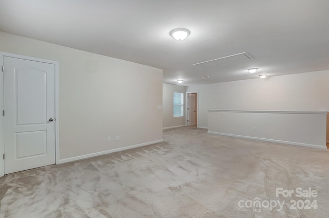 spare room featuring light colored carpet