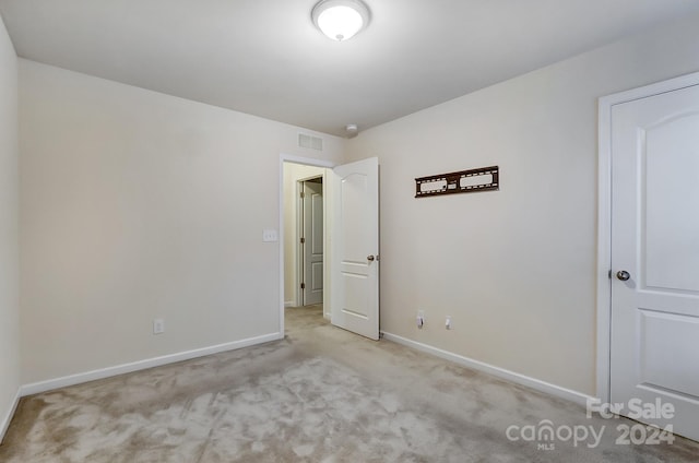 unfurnished room with light colored carpet