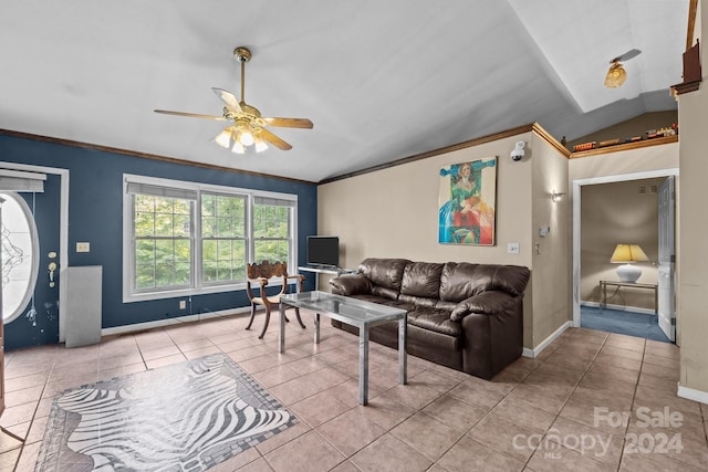 living room with lofted ceiling, ceiling fan, ornamental molding, and light tile patterned floors