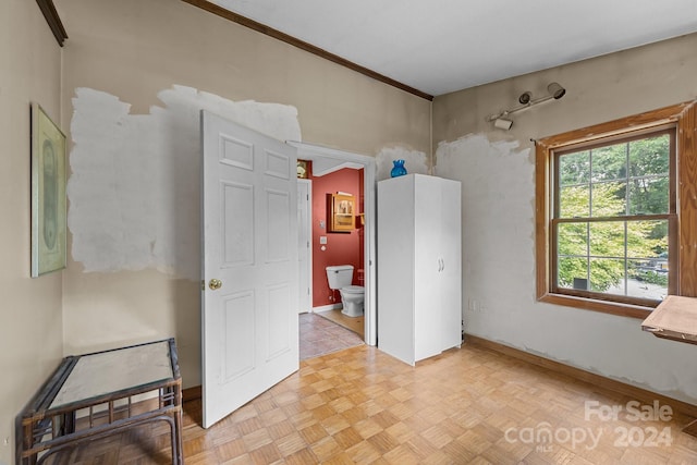 spare room with ornamental molding and light parquet floors