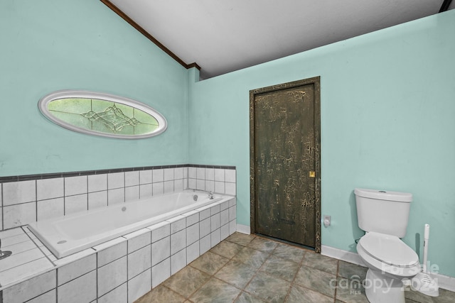 bathroom featuring tile patterned flooring, toilet, lofted ceiling, a relaxing tiled tub, and ornamental molding