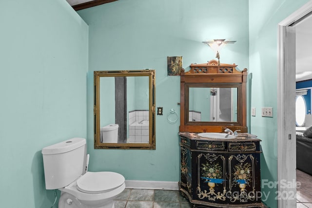 bathroom with tile patterned flooring, vanity, and toilet