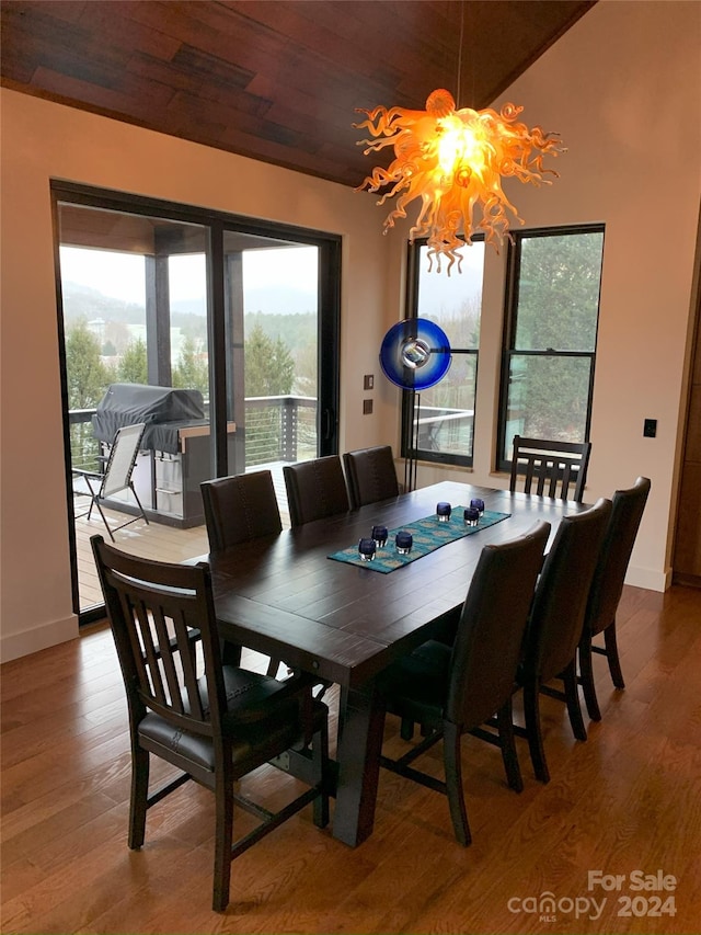 dining space featuring a chandelier, wood-type flooring, and wooden ceiling