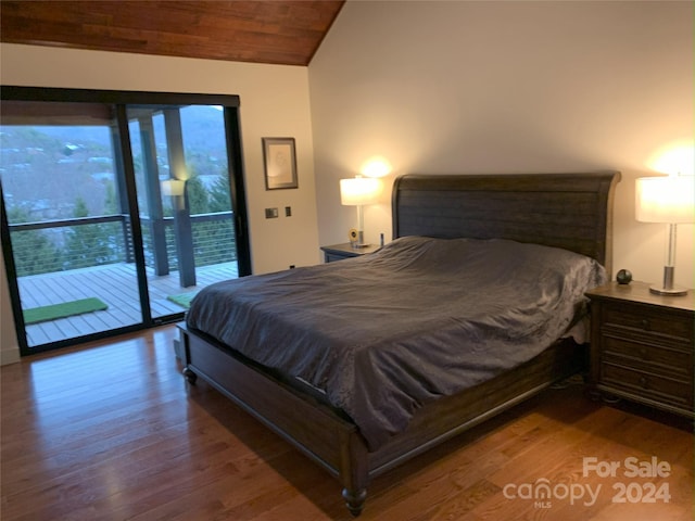 bedroom featuring lofted ceiling, wood-type flooring, and access to exterior