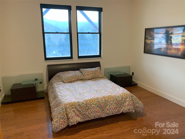 bedroom with wood-type flooring