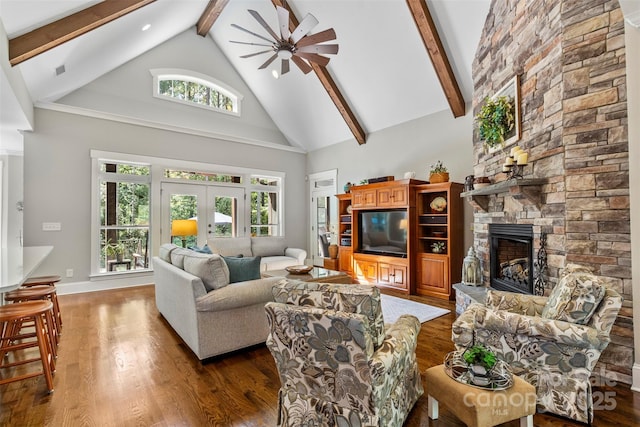 living room featuring high vaulted ceiling, a stone fireplace, ceiling fan, dark hardwood / wood-style floors, and beam ceiling