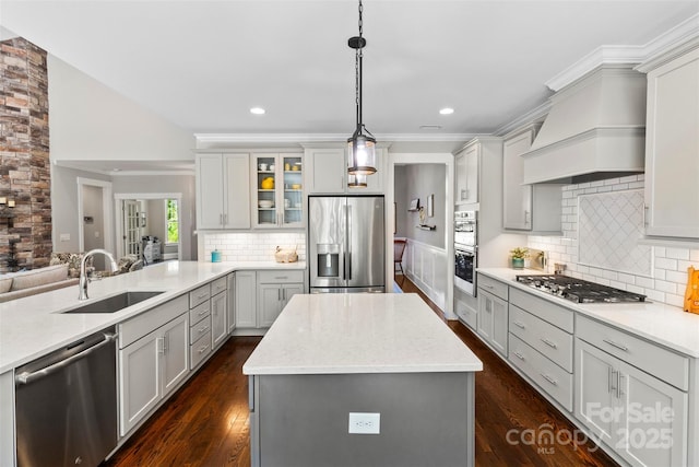 kitchen with decorative light fixtures, decorative backsplash, stainless steel appliances, and custom range hood