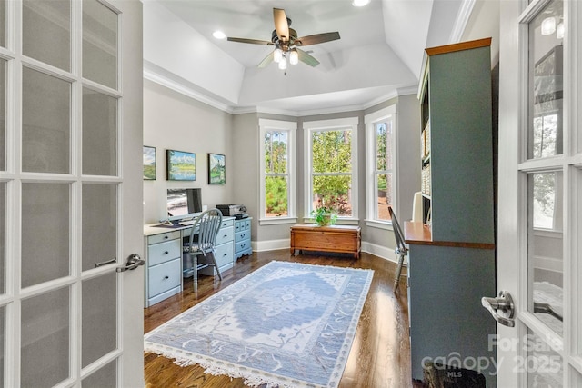 office space featuring ceiling fan, french doors, dark wood-type flooring, a raised ceiling, and crown molding