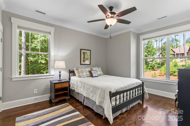 bedroom with ceiling fan, dark wood-type flooring, and ornamental molding