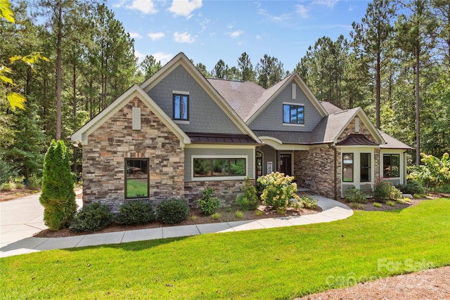 craftsman inspired home with a front lawn