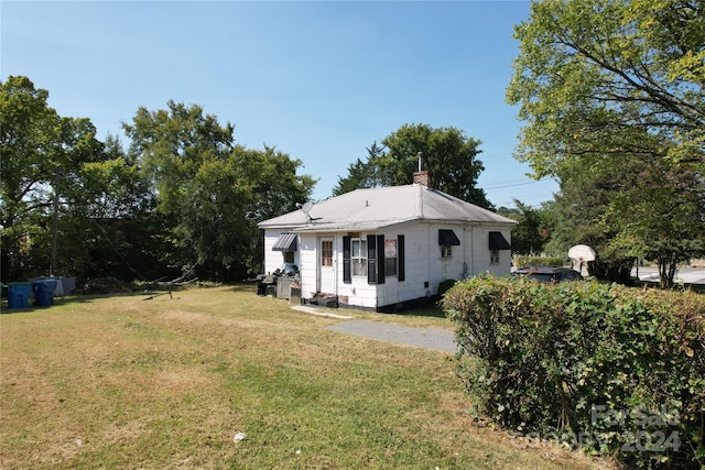 110 Sims Pkwy, Harrisburg, NC 28075 - exterior space with a chimney and a front yard