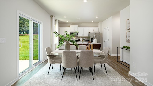 dining area with hardwood / wood-style floors