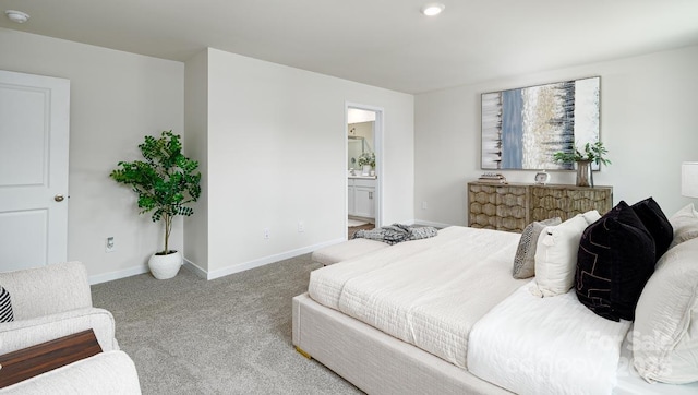 carpeted bedroom featuring ensuite bath