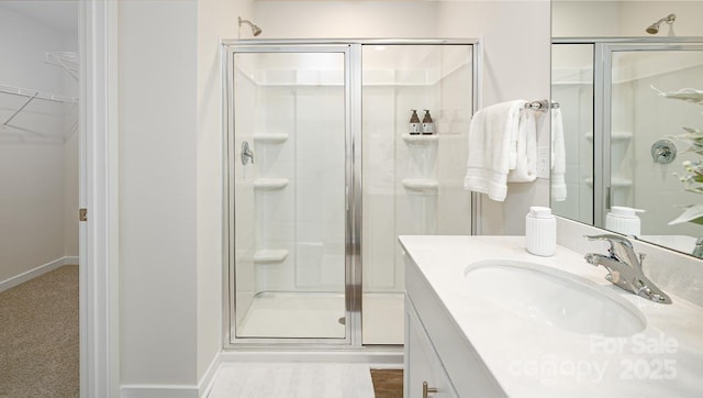 bathroom with walk in shower and vanity