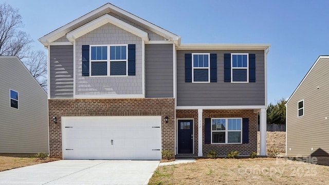 craftsman-style home with a garage, concrete driveway, and brick siding