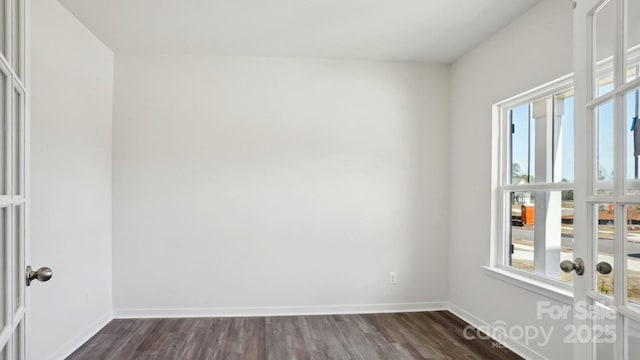 unfurnished room with dark wood-style floors, baseboards, and french doors