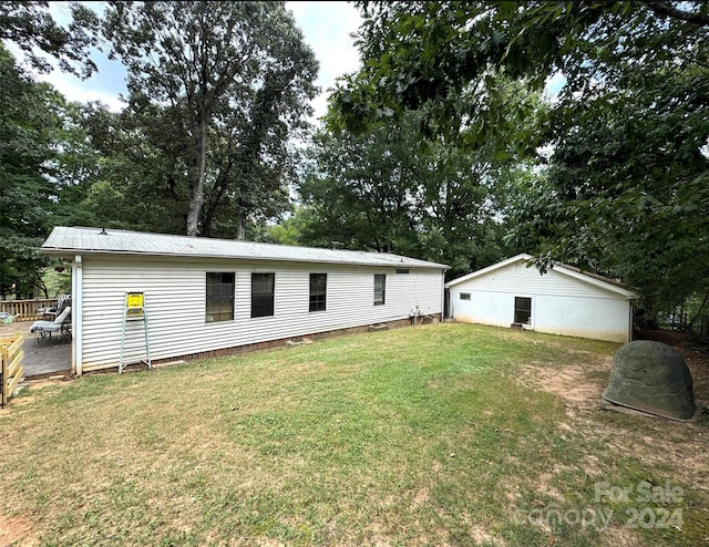 back of property featuring a yard and a deck