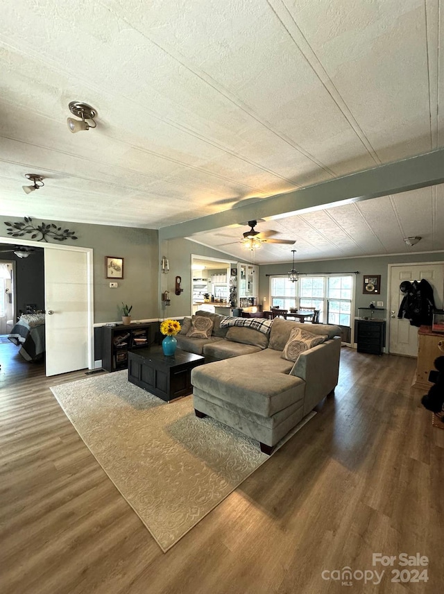 living room with ceiling fan, wood-type flooring, and a textured ceiling