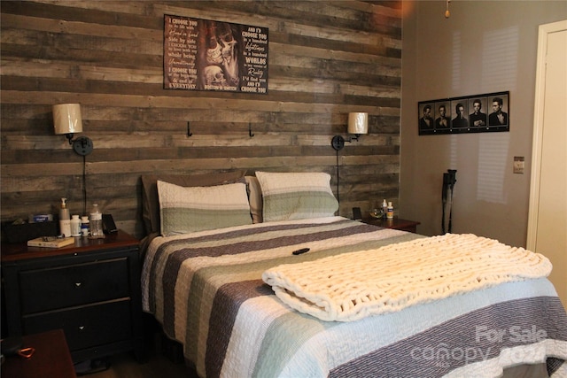 bedroom featuring wood walls