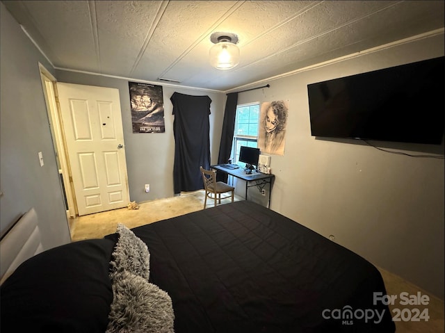 bedroom featuring a textured ceiling and carpet floors