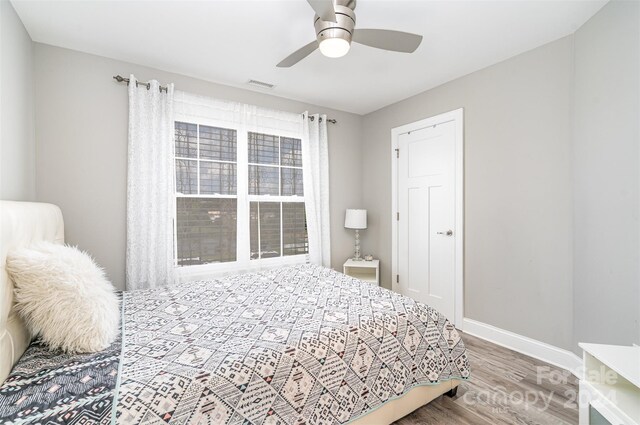 bedroom with hardwood / wood-style floors and ceiling fan