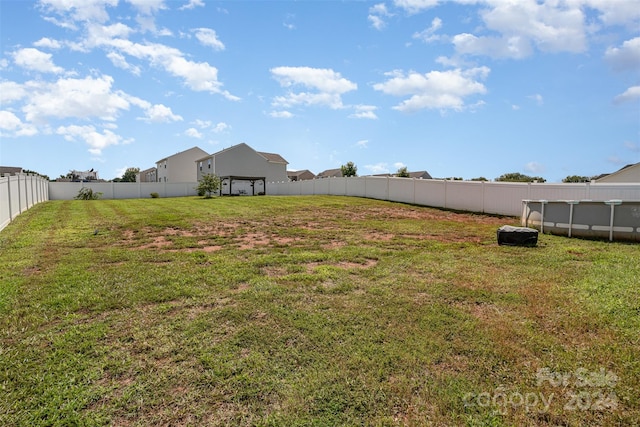 view of yard with a fenced in pool