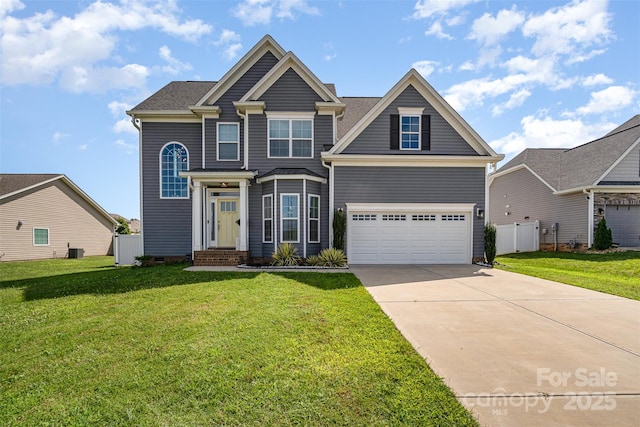 view of front of property with a garage, concrete driveway, a front lawn, and fence