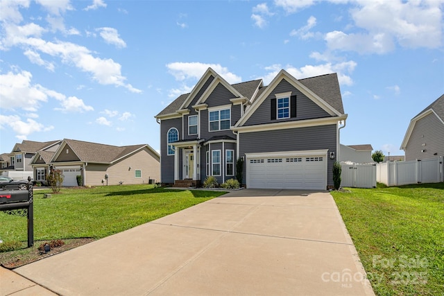 craftsman house with a gate, a front lawn, driveway, and fence