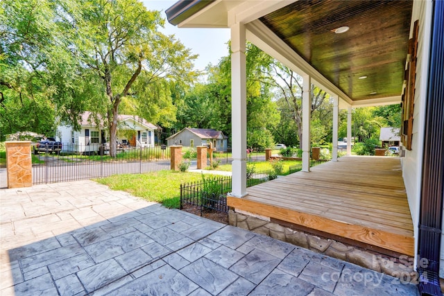 view of patio / terrace with a porch and a fenced front yard