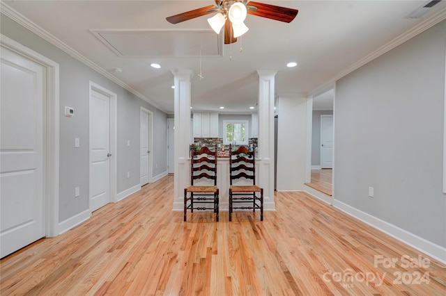 dining area with ornamental molding, light hardwood / wood-style flooring, ceiling fan, and decorative columns