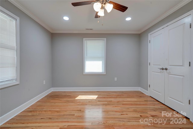 unfurnished bedroom featuring ceiling fan, light hardwood / wood-style floors, and ornamental molding