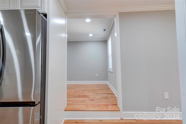 interior space with hardwood / wood-style floors and ornamental molding